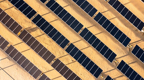 Photo depicts aerial Sunrise View over Solar Panels in Palm Springs California