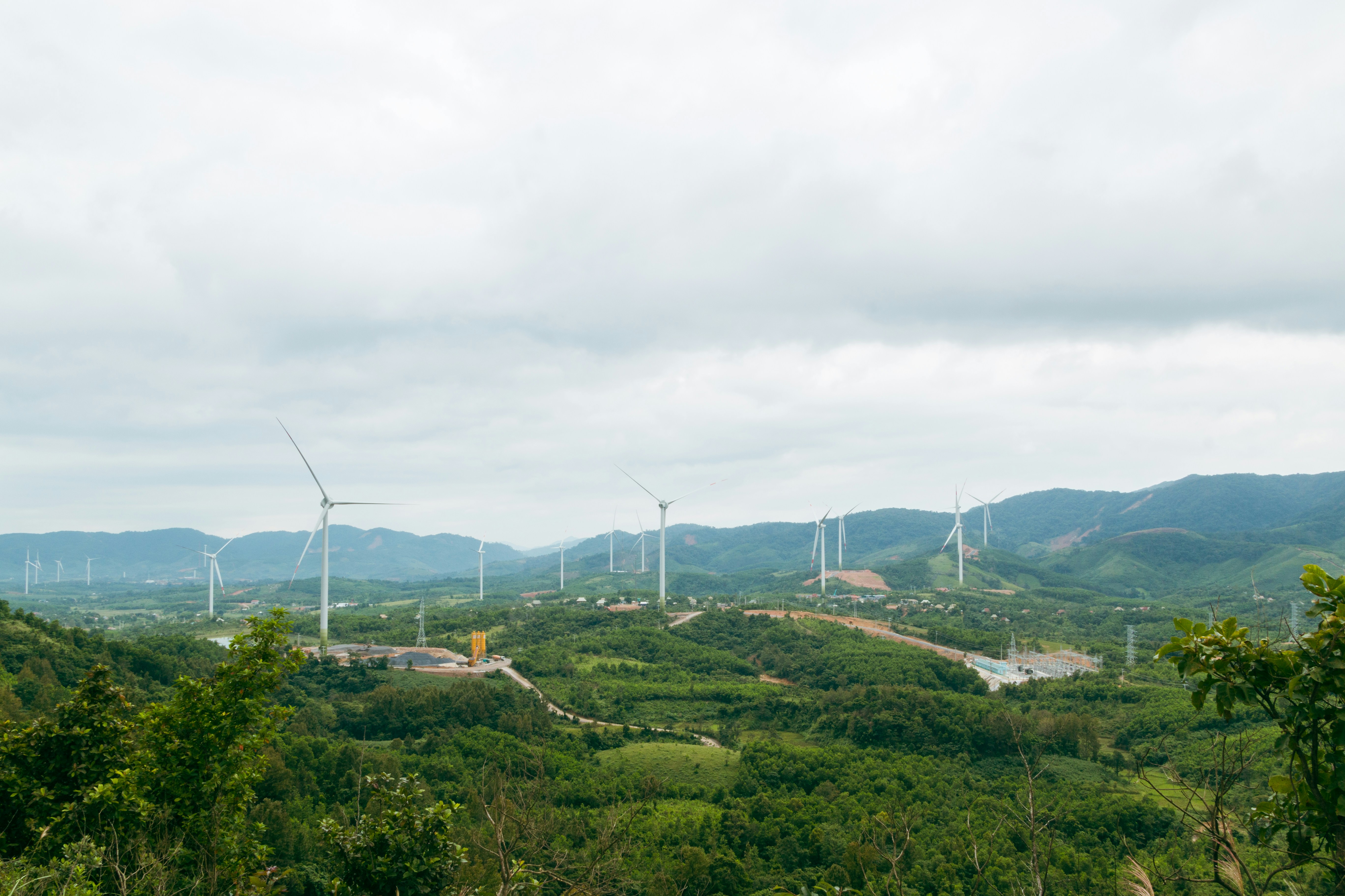 Photo depicts A view of a wind farm in the mountains