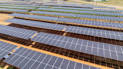 Photo depicts of Solar panels on tomato field for agriculture, development of rural areas and cities in Africa.