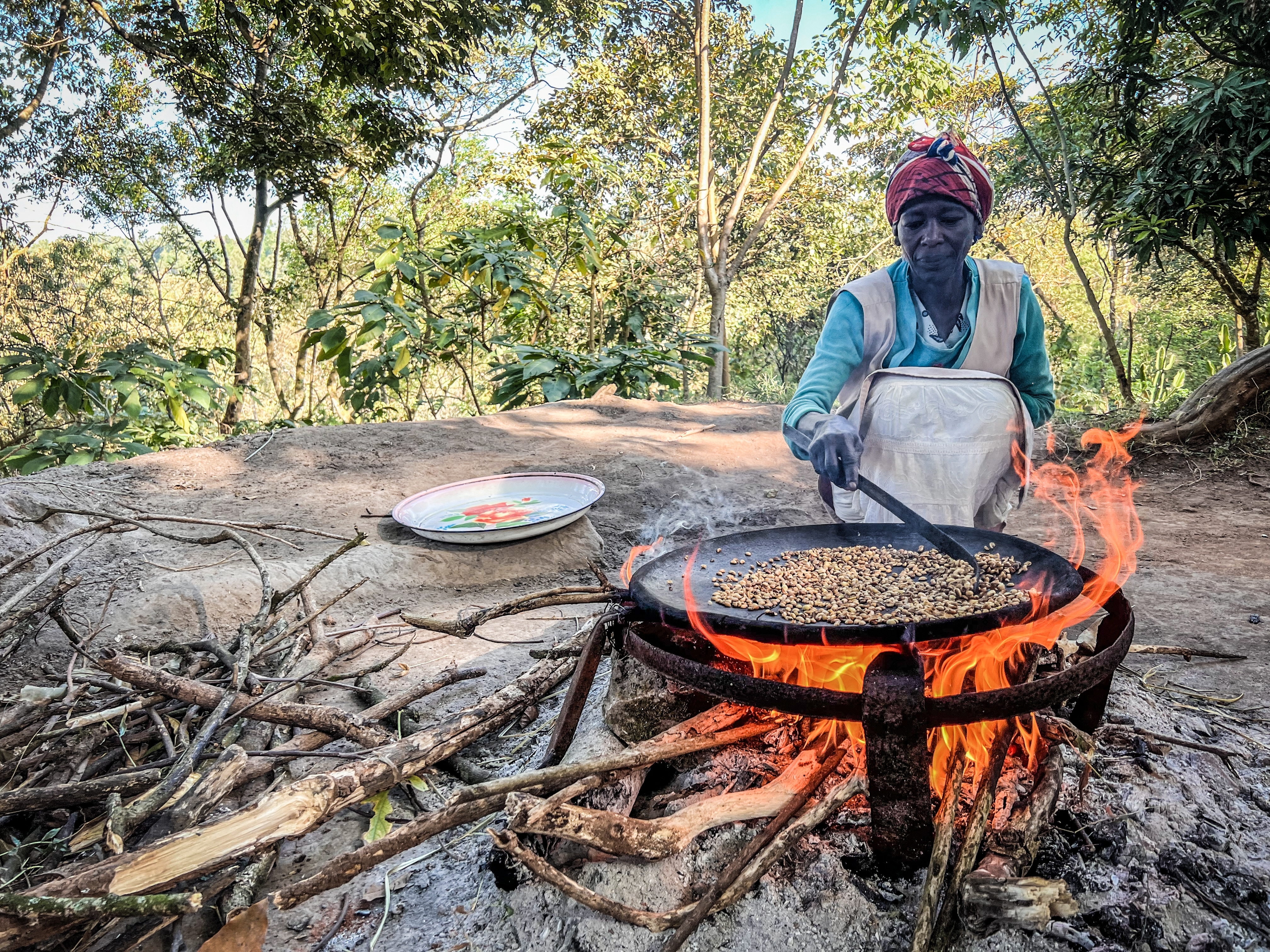Photo depicts a woman cooking coffee to make traditional Buna - Yirga Alem, Ethiopia