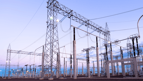 Cover of Electricity Market Report 2023 - A photograph of a power plant at sunrise