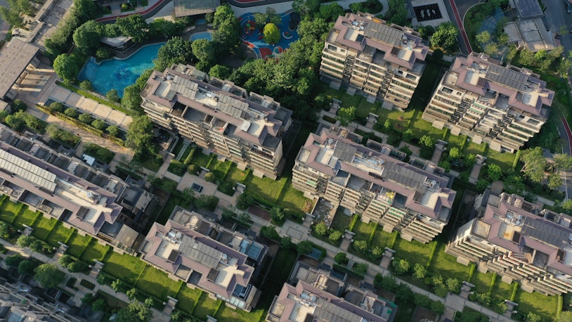 Photo depicts Aerial top view of modern European townhouse buildings in China