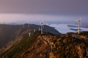 Wind Turbines On Top Of Mountain With Clouds Underneath Shot At Sunrise In Kuocang Mountain Zhejiang China Shutterstock 1715606569