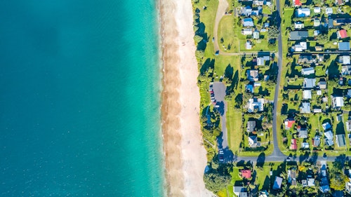 Aerial View Of A Small Suburb Next To A Sunny Beach By The Ocean  Coromandel Peninsula New Zealand Gettyimages 821756102