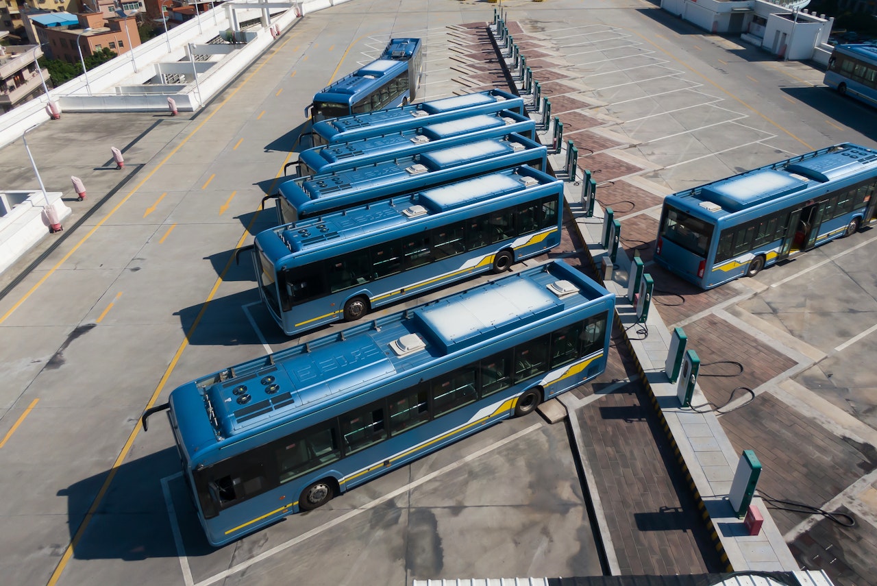 Electric buses charging on a parking lot
