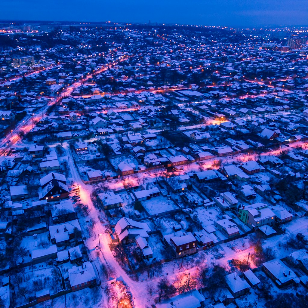 Evening aerial view to residential area Zhuravlivka in Kharkiv with snow, Ukraine