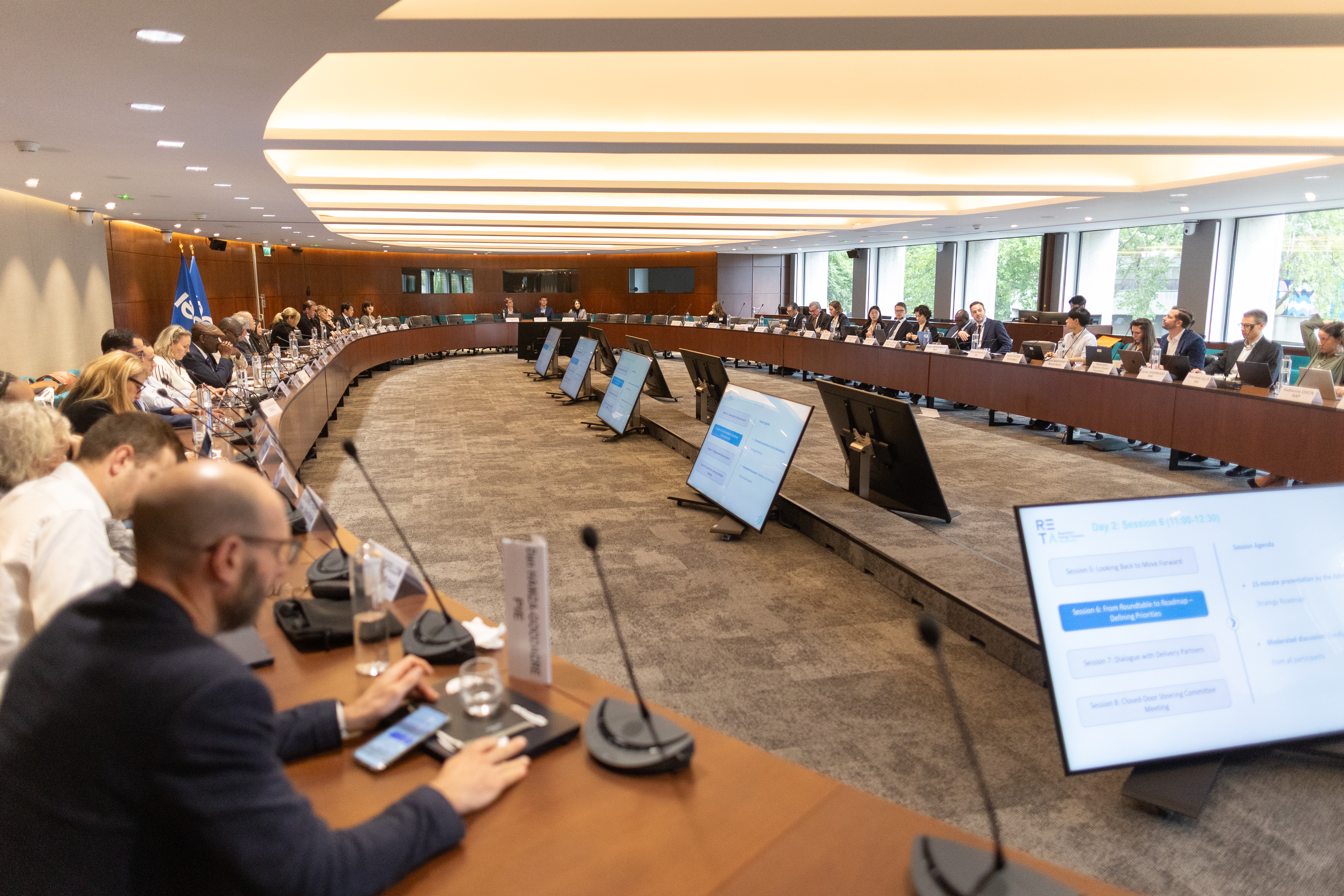 Photo shows a large conference room with members of the RETA roundtable A9A8982