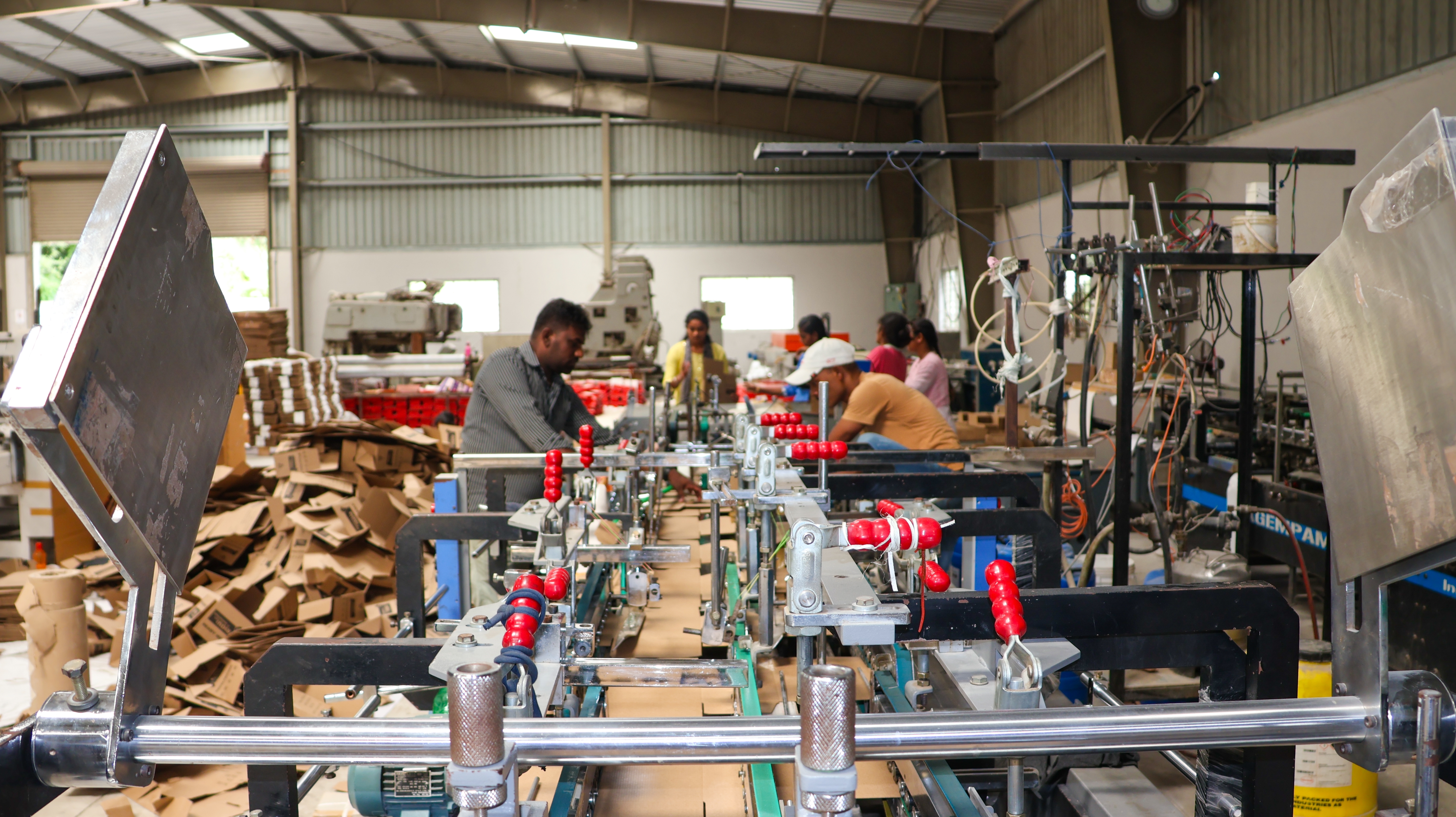 photo depicts in Bangalore, India, August 1, 2024: Modern factory for the production of corrugated cardboard boxes and related products. Storage and paper products. Packaging industry. Cartoning solutions.