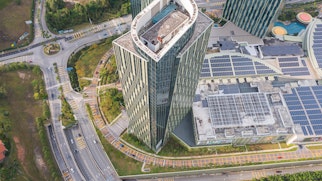 Cover Of Efficient Grid Interactive Buildings Top View Of Asphalt Road Passes Shopping Mall With Solar Panel On The Roof
