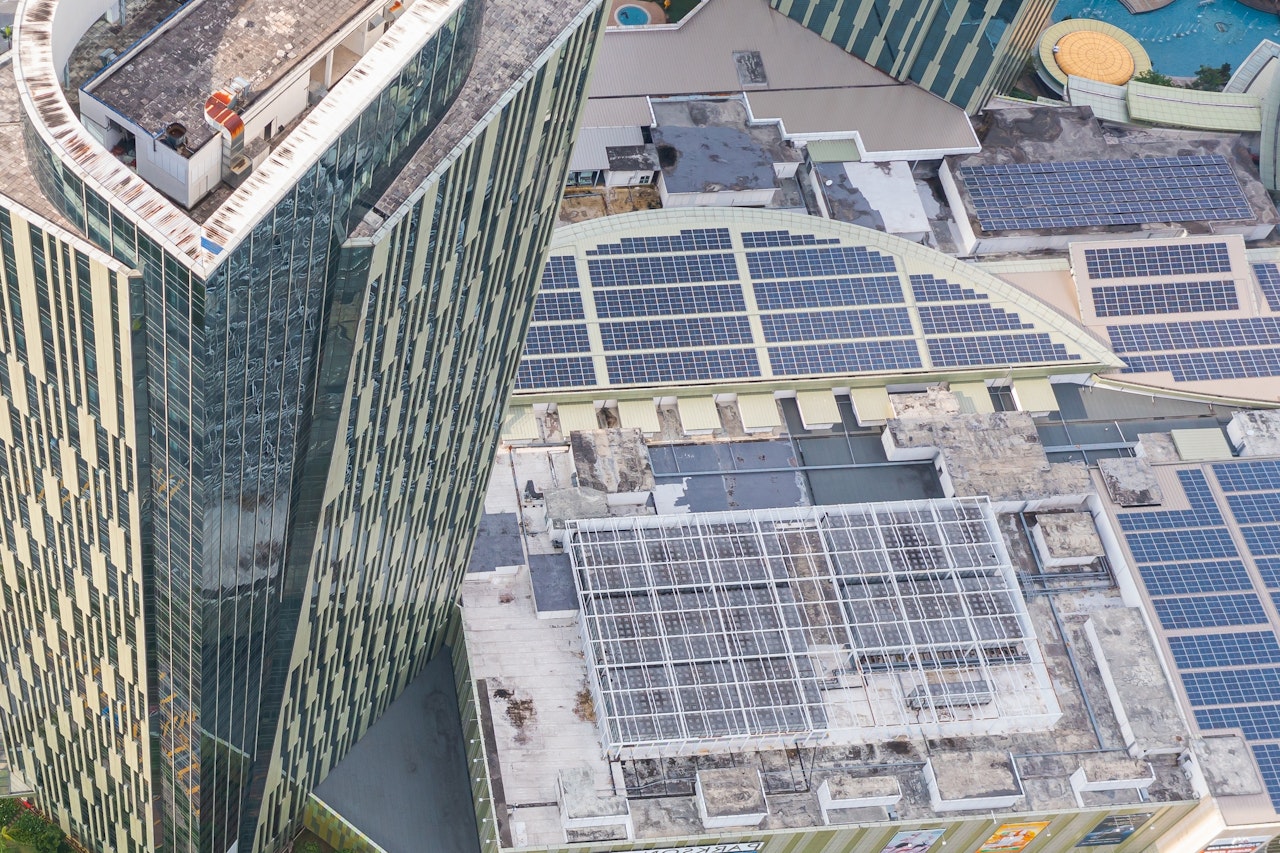 Cover Of Efficient Grid Interactive Buildings Top View Of Asphalt Road Passes Shopping Mall With Solar Panel On The Roof