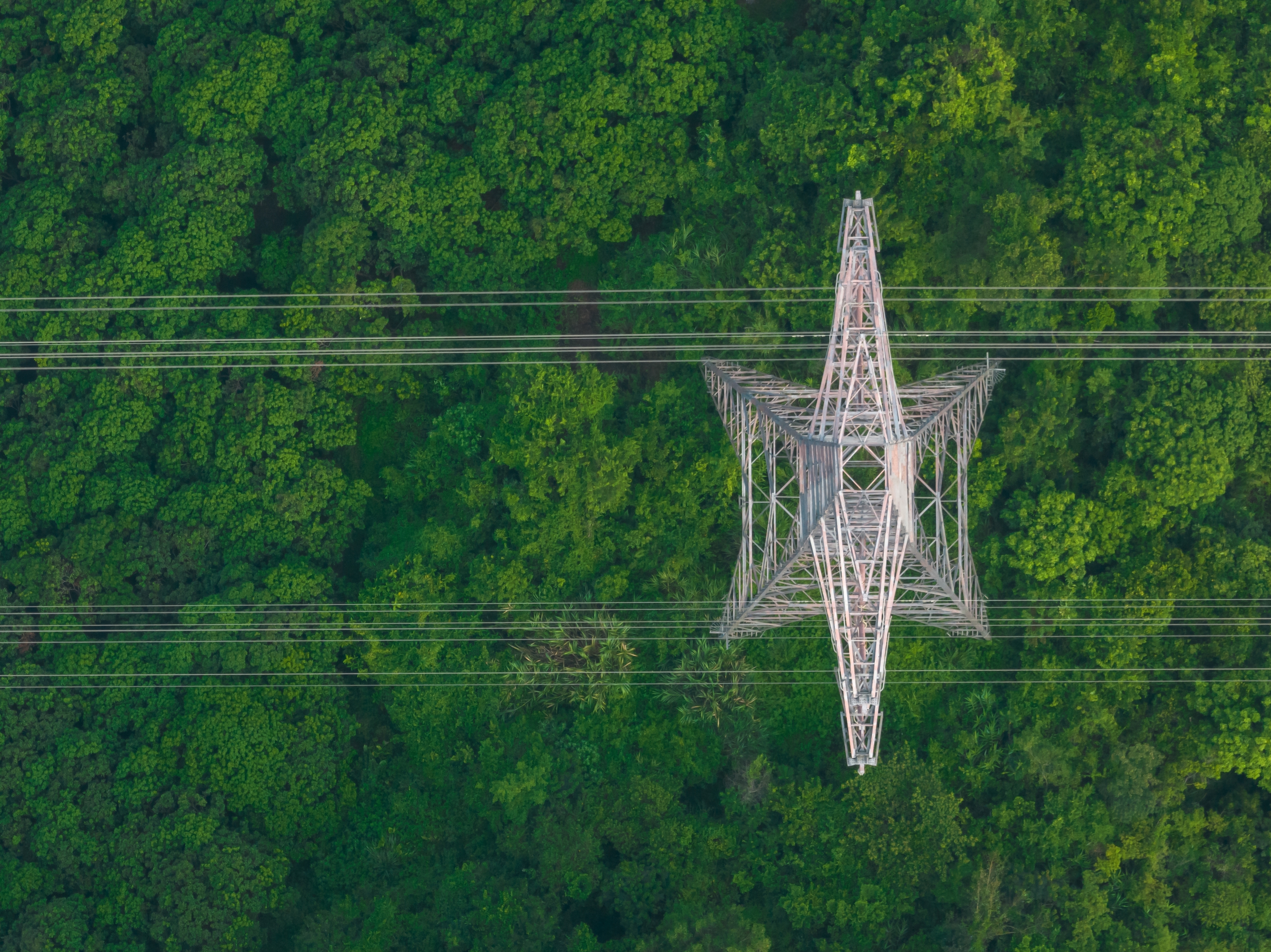 Photo depicts Aerial view of the electricity tower on the mountain.