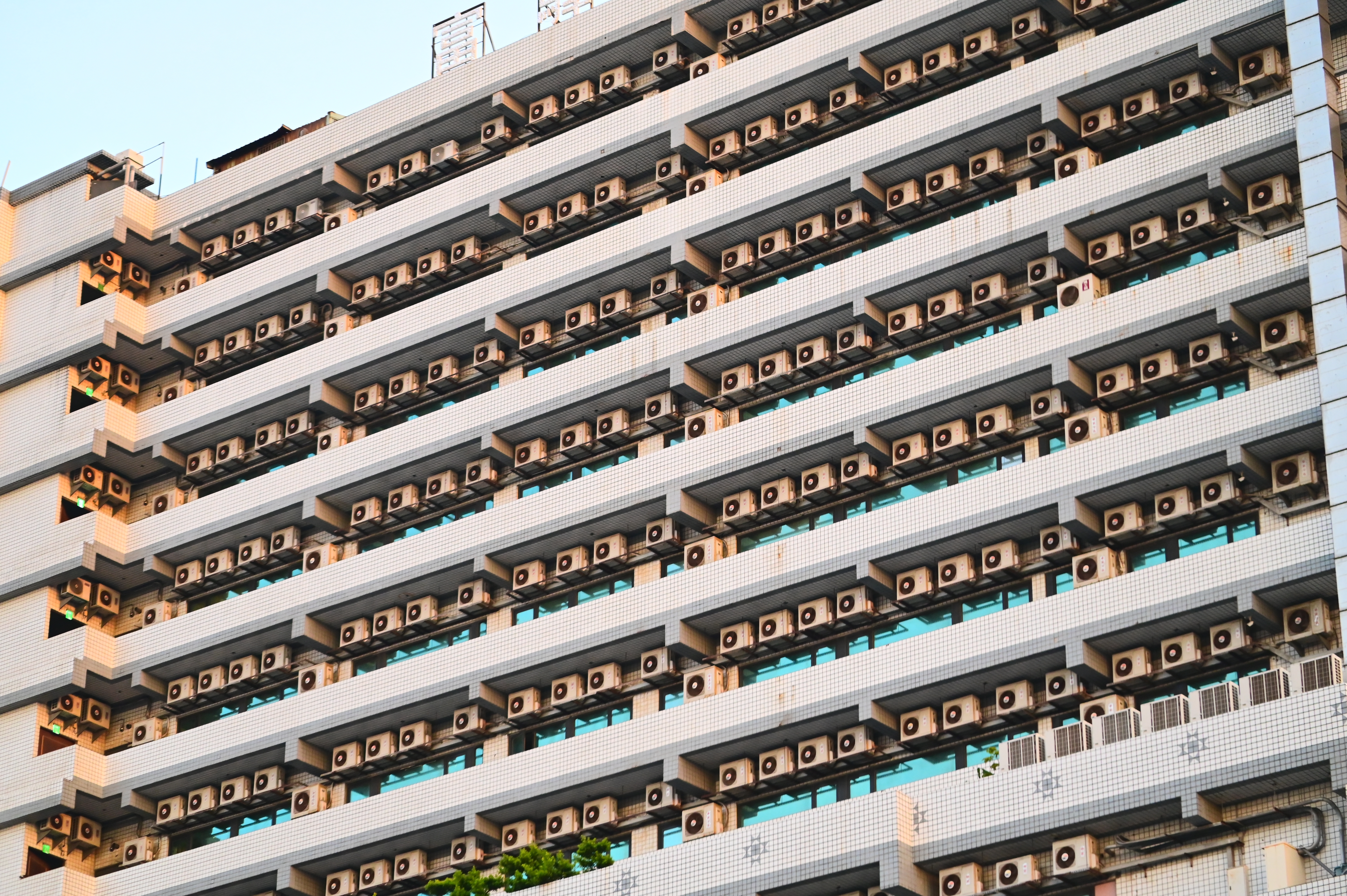 Photo depicts Taiwan - July 8, 2024: With rising global temperatures, air conditioning is essential for cooling, but increases energy consumption, greenhouse gas emissions, and urban heat island effects.