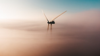 Cover Image Of Renewables 2022 A Photo Of A Wind Turbine Through Soft Hazy Clouds