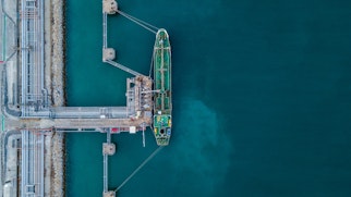 Photo depicts an aerial view oil tanker ship at the port, Import export business logistic and transportation by tanker ship.