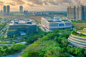 Photo of Large Buildings With Green Rooftops In Green Area