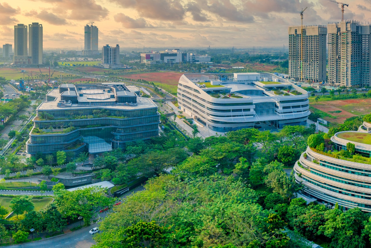 Photo of Large Buildings With Green Rooftops In Green Area