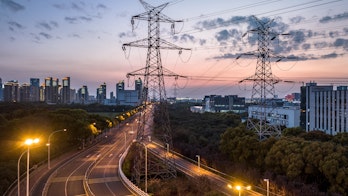 Photo depicts high-voltage power lines. high voltage electric transmission tower at sunset.