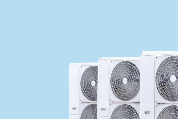 Photo shows three heat pumps on a blue background