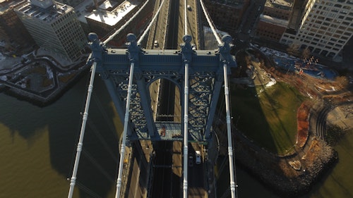 Aerial View Of Manhattan Bridge With Buildings On The Sides Shutterstock 591394799