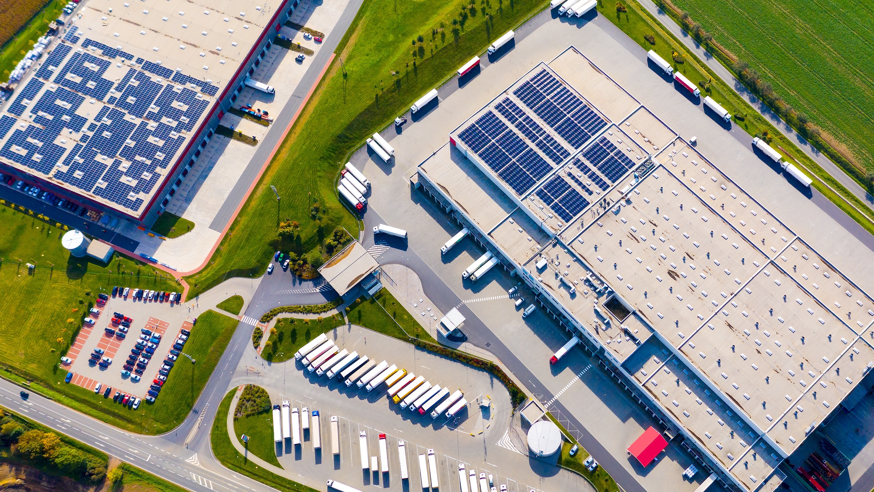 Industrial Warehouses With Solar Panels On The Roof Shutterstock 2211240323 Clean Energy Is Boosting Economic Growth