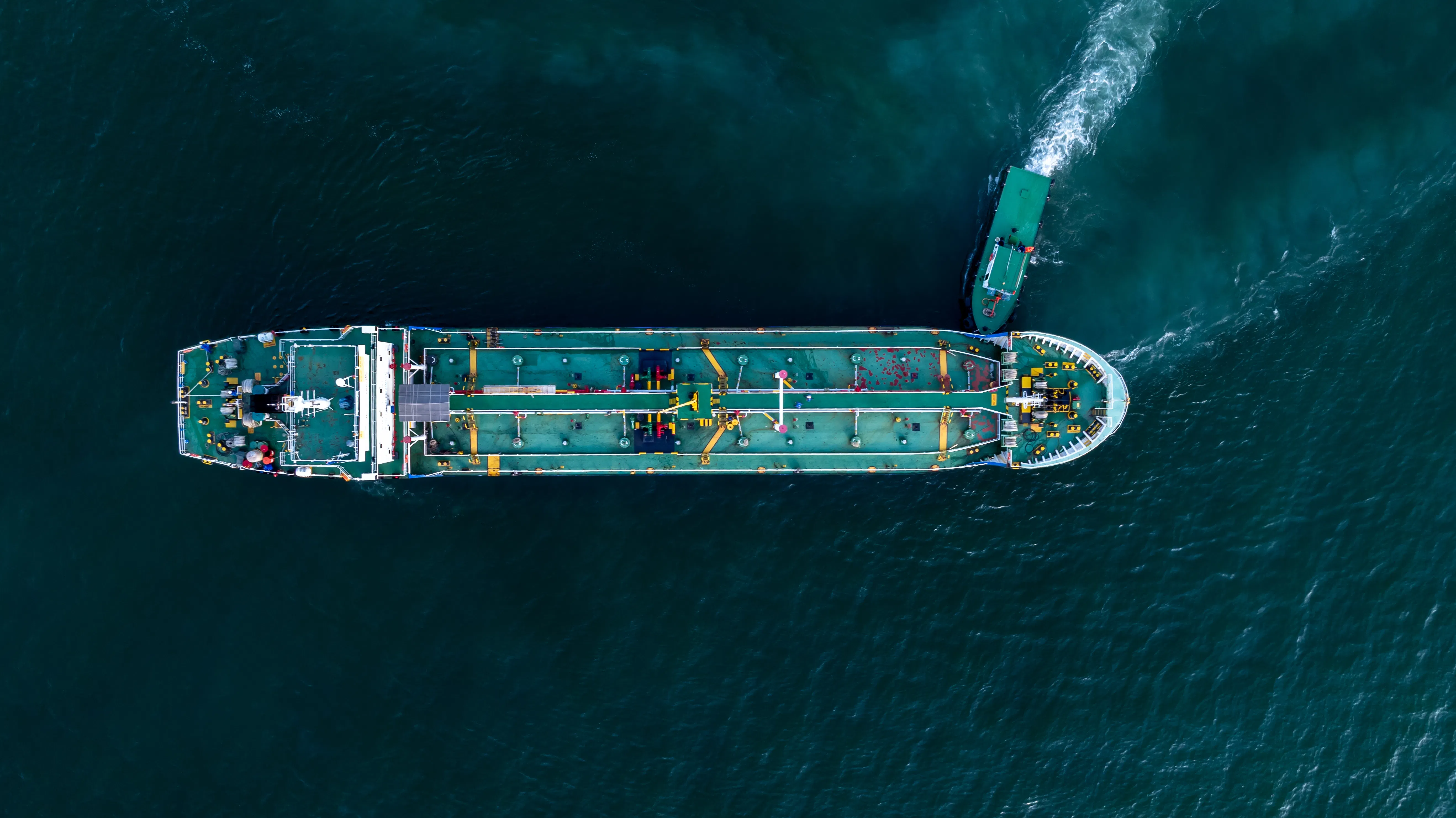Aerial view of a crude oil tanker and tugboat, Global business import freight transport of crude oil freight logistics international transport, crude oil tanker industrial sea freight maritime logistics